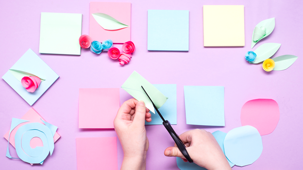 Bride cutting out invitations