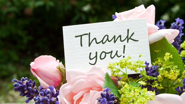 a thank you card in a flower bouquet
