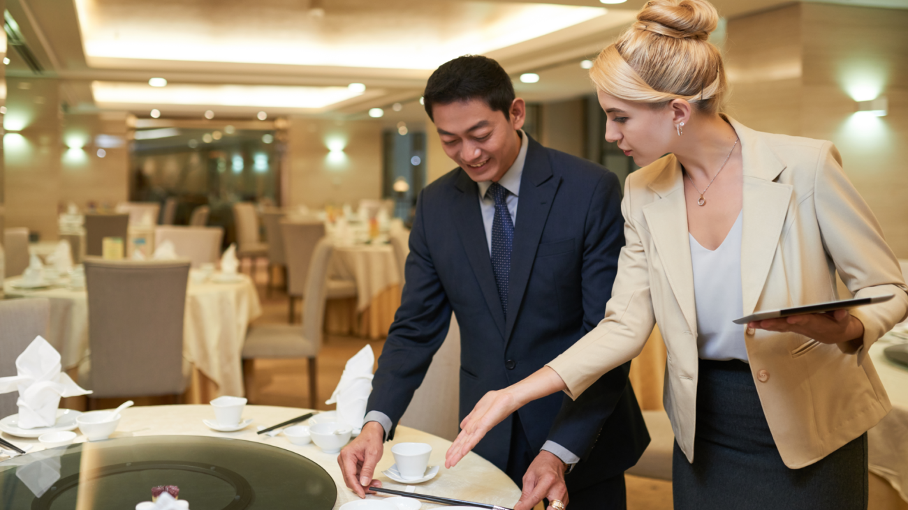a wedding planner and banquet manager discussing table setting