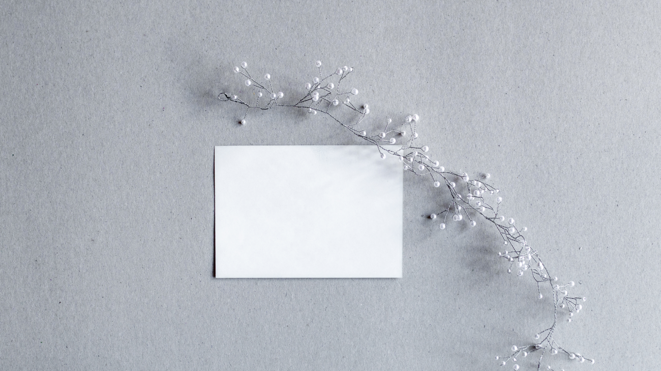 a blank card with a metal decoration