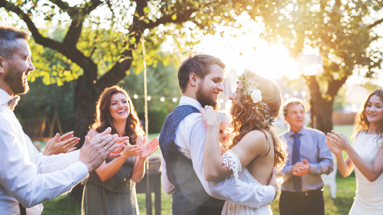 a bride and groom dancing outside at their outdoor wedding reception