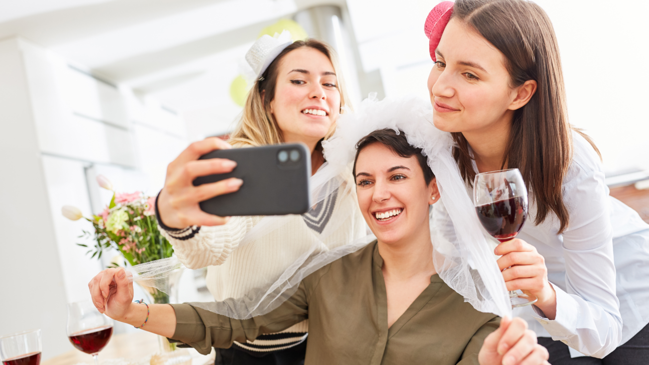 a bride takes a selfie with her girlfriends
