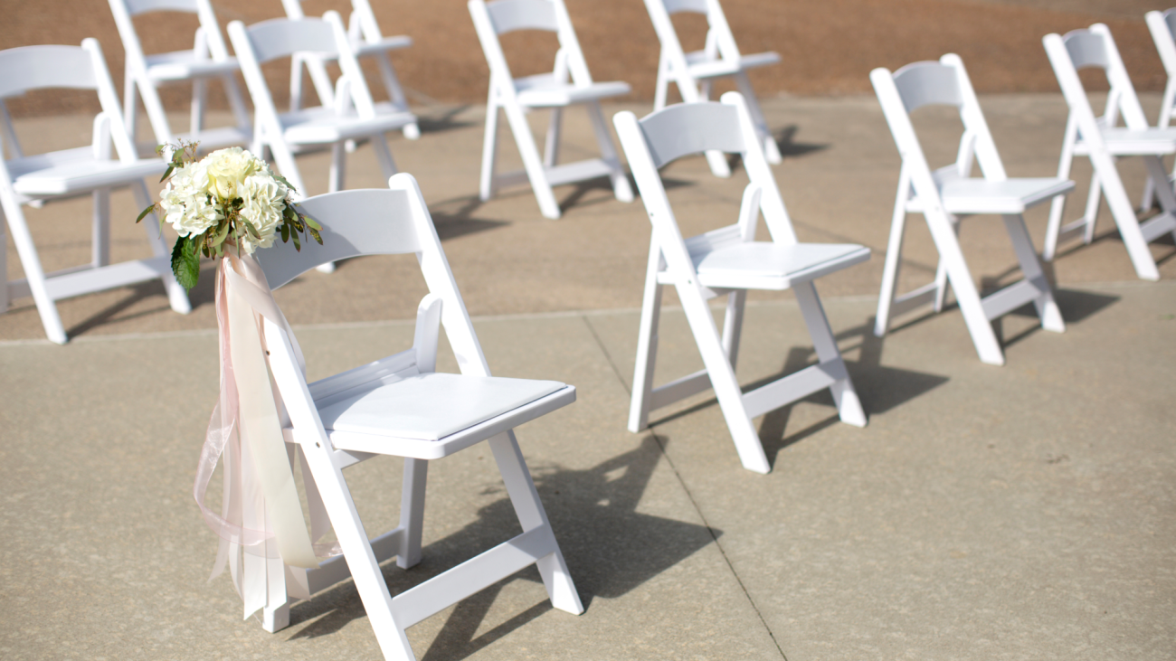 chairs seated apart from each other at a wedding ceremony