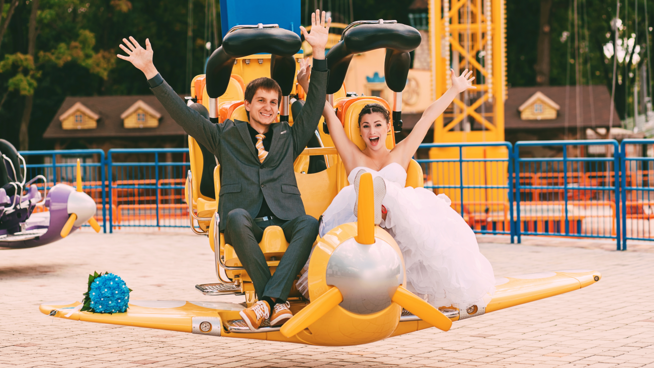 a cheerful married couple sitting on an airplane in a playground park