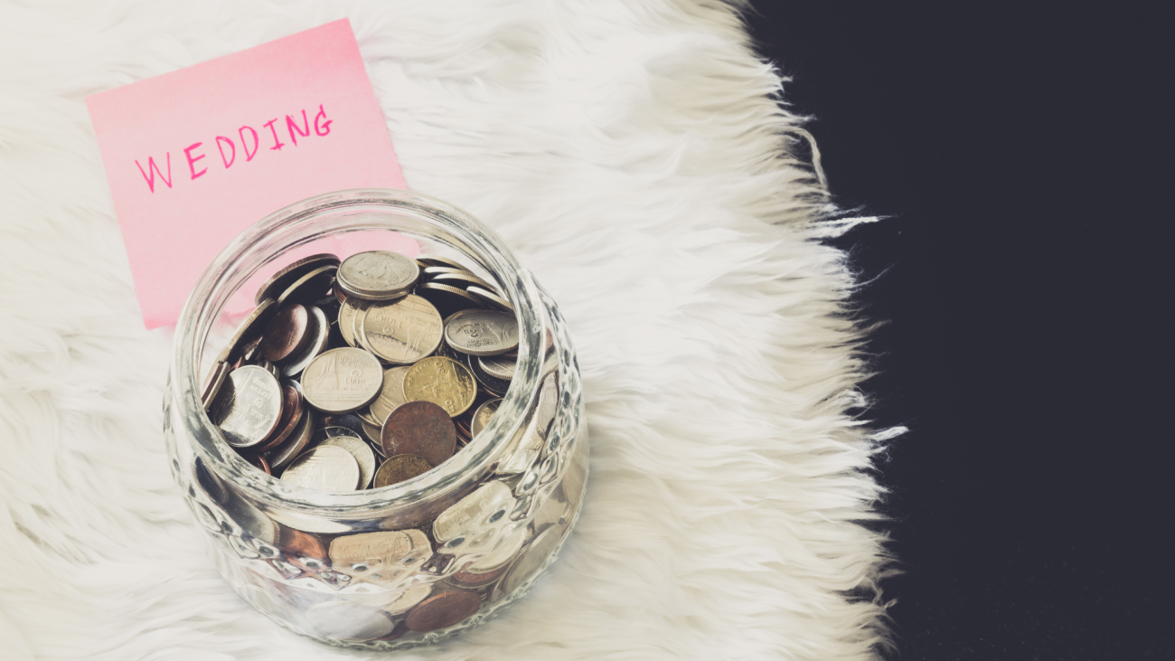 coins in a money jar with attached “wedding” post-it note