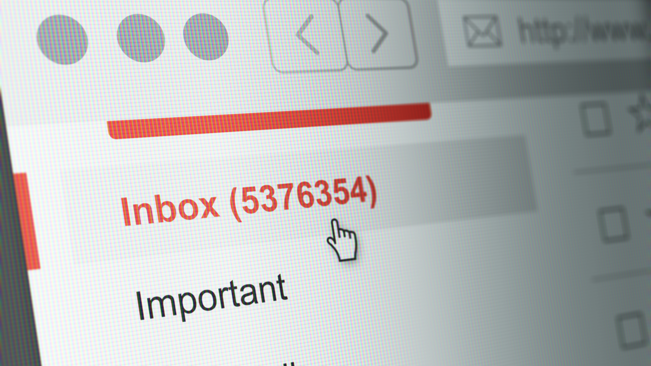 a computer monitor screen displays an email inbox with millions of unopened emails