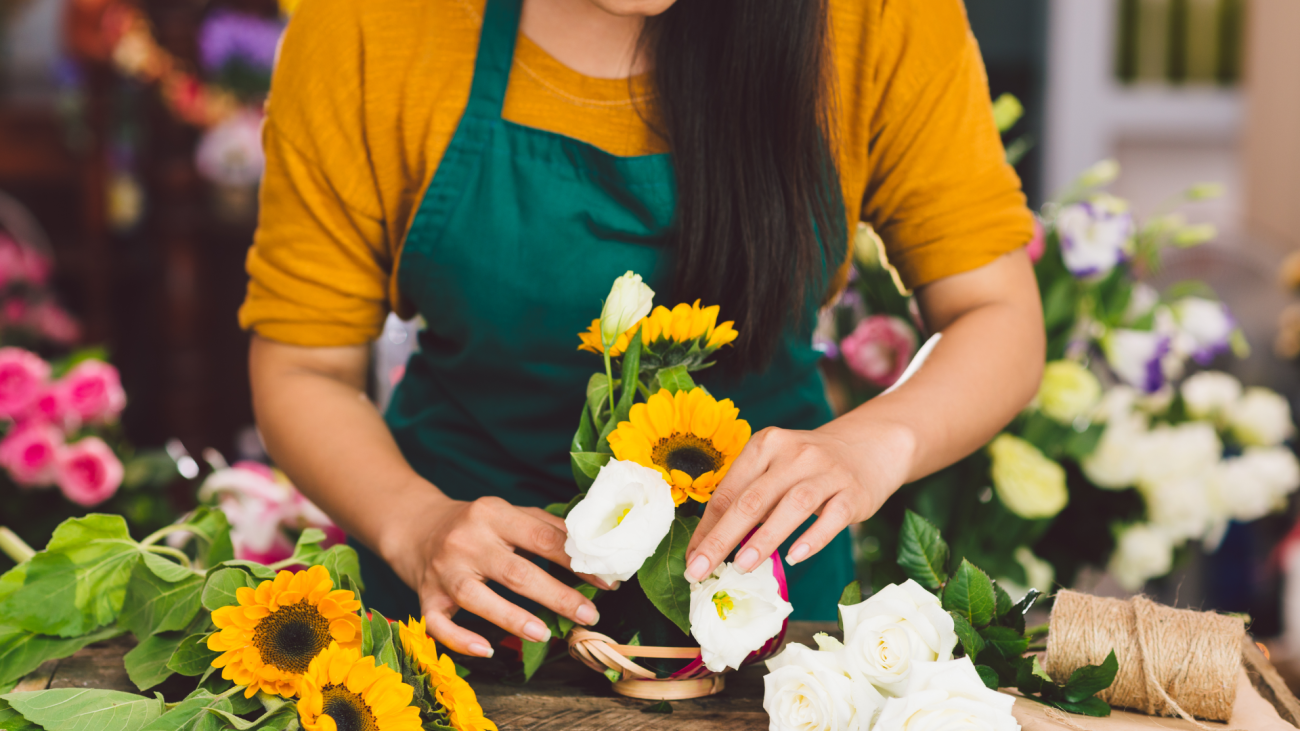 a florist arranges flowers