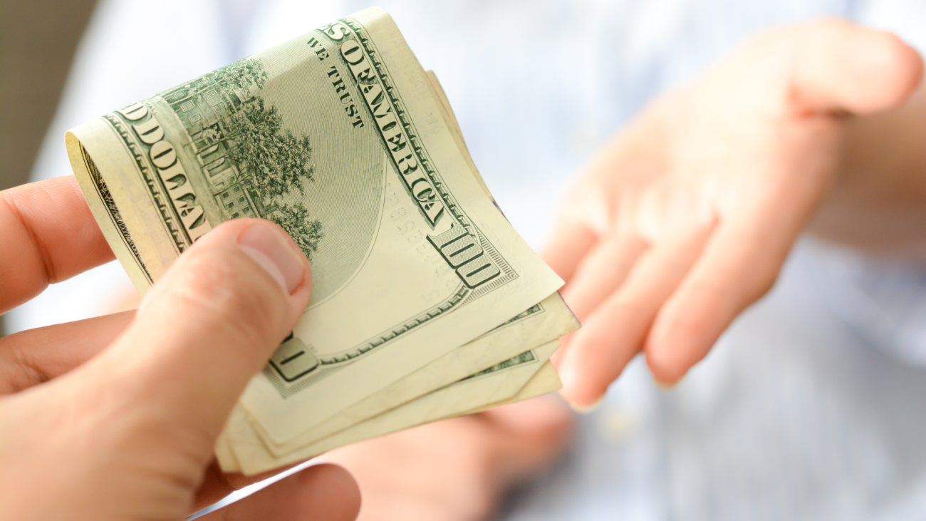 two people exchanging money