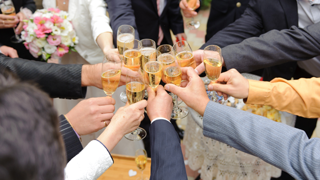 guests clanging glasses at a wedding party