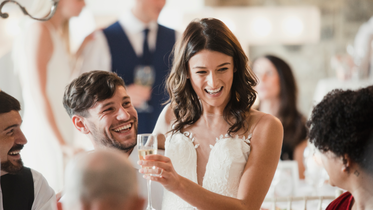 a happy bride and groom are socialising with the guests at their wedding reception