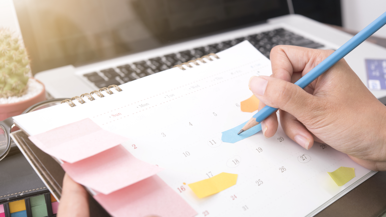 a person makes a schedule on their calendar