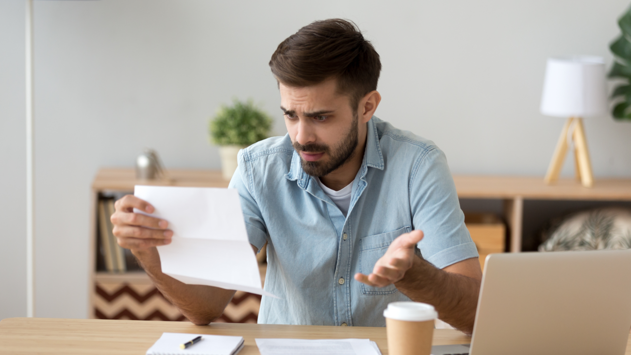 a man is confused while reading a letter