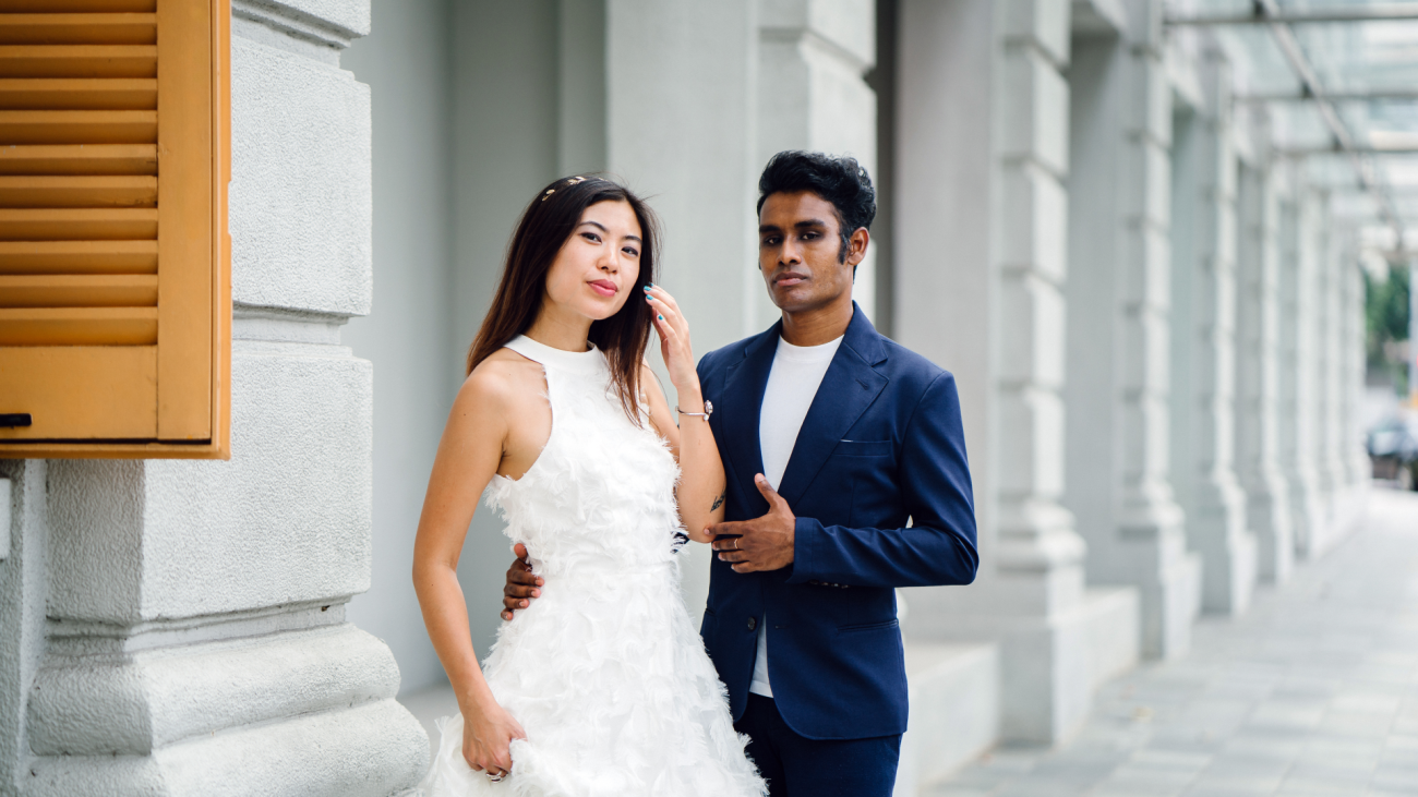 a newlywed couple stand in front of a court house