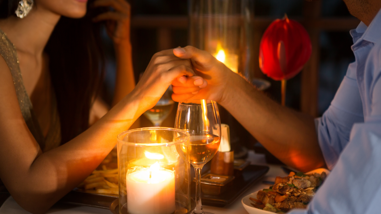 a couple sitting down for a romantic candlelight dinner