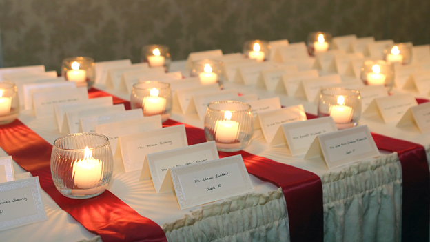 small candles light placecards for wedding guests at a wedding reception