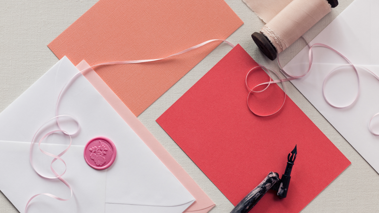 a top-down view of blank pink thank-you notes or wedding-invitations