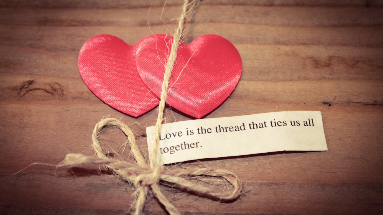 two hearts tied together with the quote “love is the thread that ties us all together
