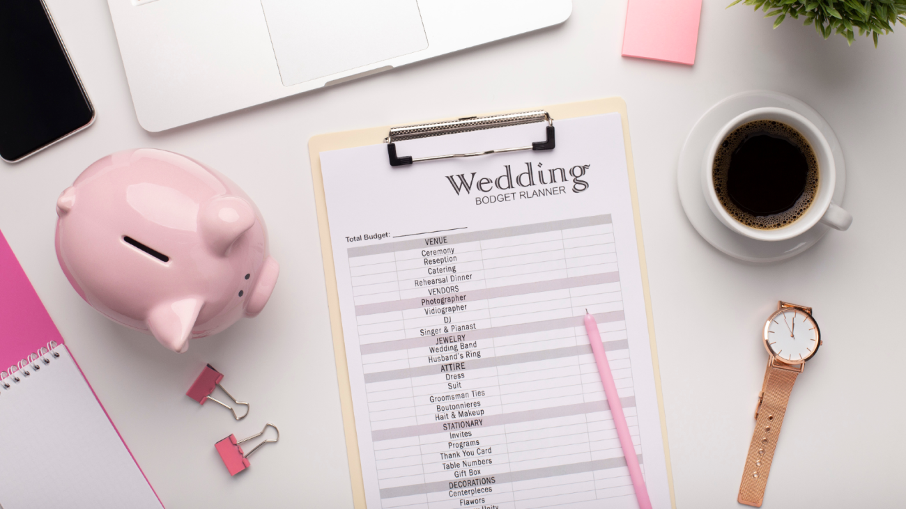 a wedding checklist sitting next to a piggy bank and a cup of coffee