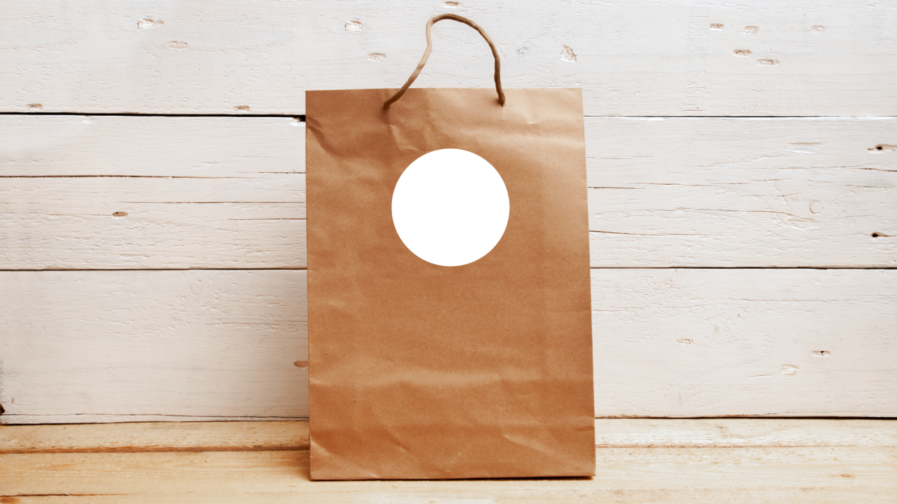 a brown wedding gift bag with a white circle on the front