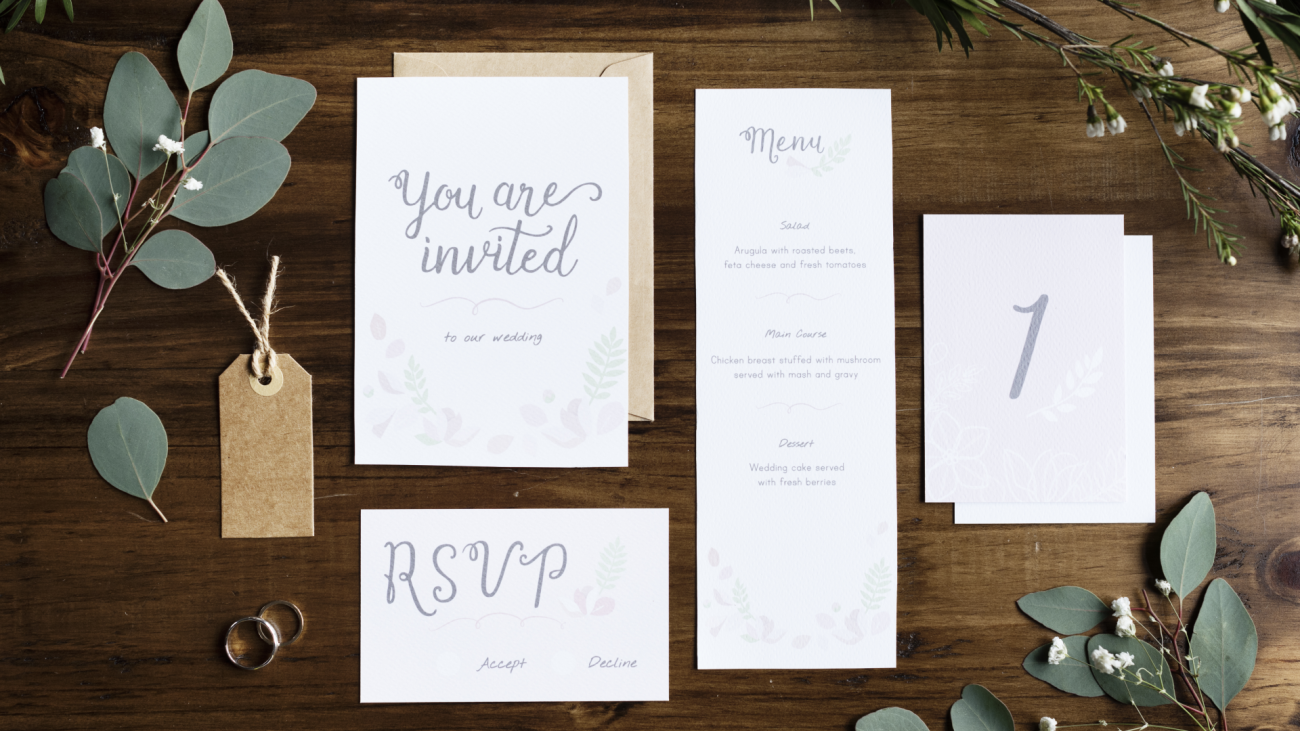 a set of wedding invitation cards, menu, RSVP, and a table setting