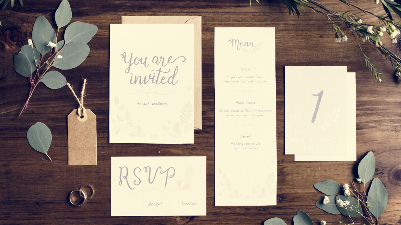 a wedding invitation, a wedding RSVP card, a wedding menu, and a wedding table setting