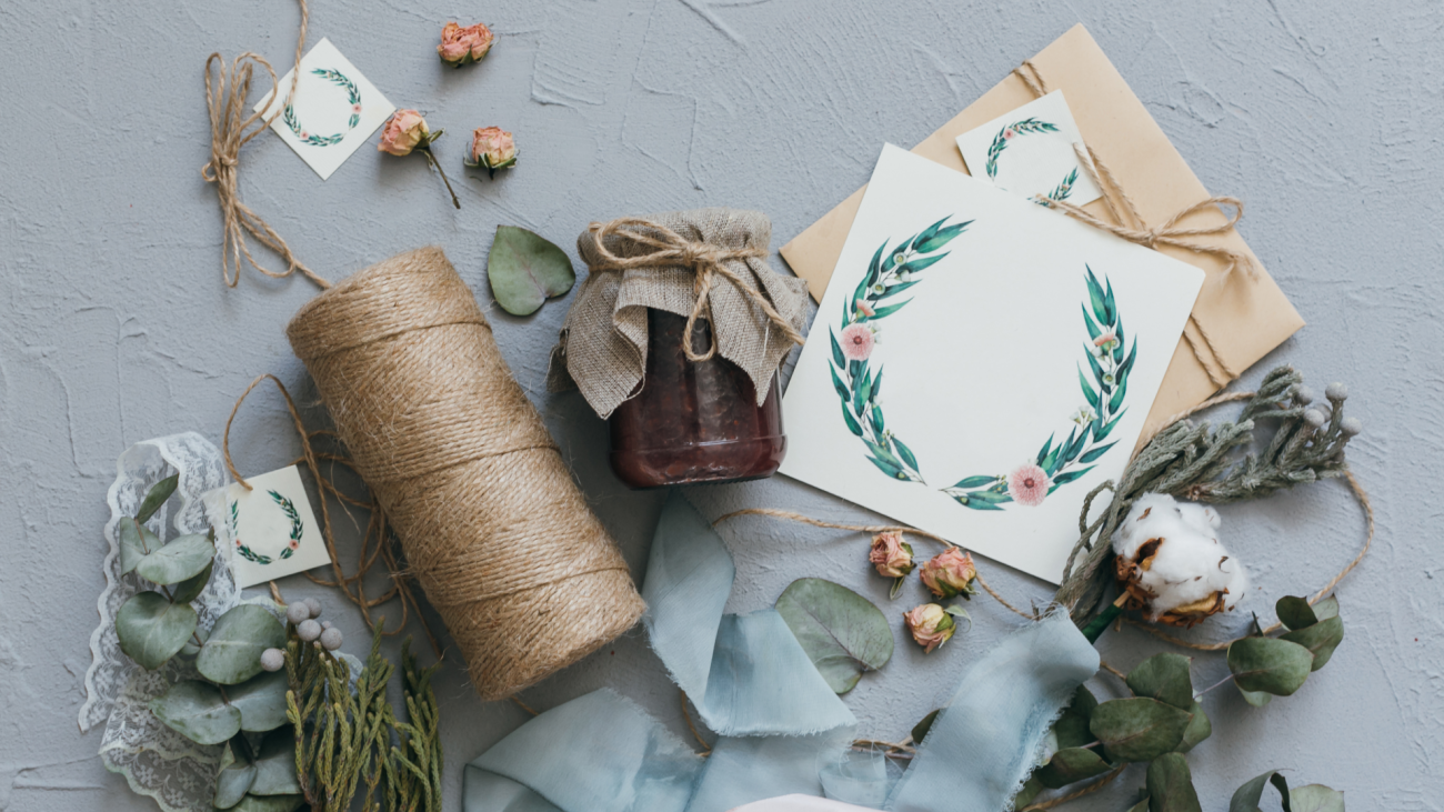 a collection of wedding stationery with flowers and thread