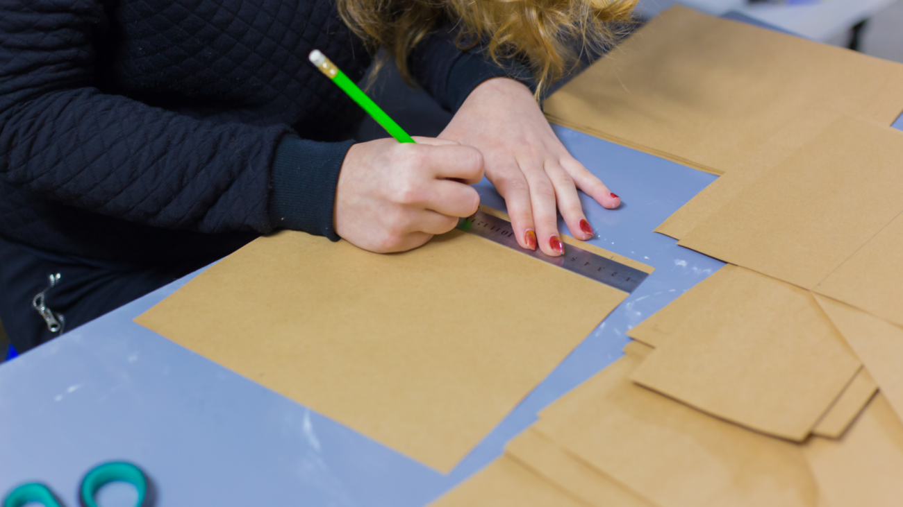 a woman cuts up paper for an arts and crafts DIY project