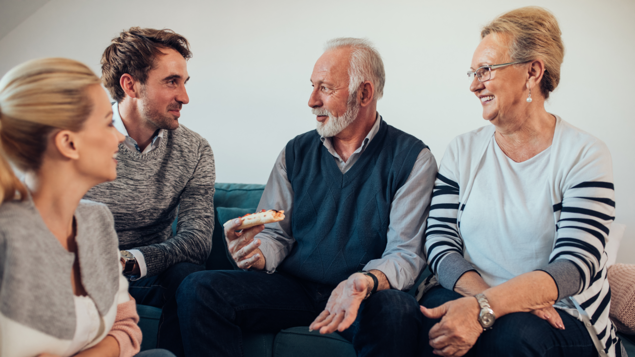 a young couple talking to one of their parents