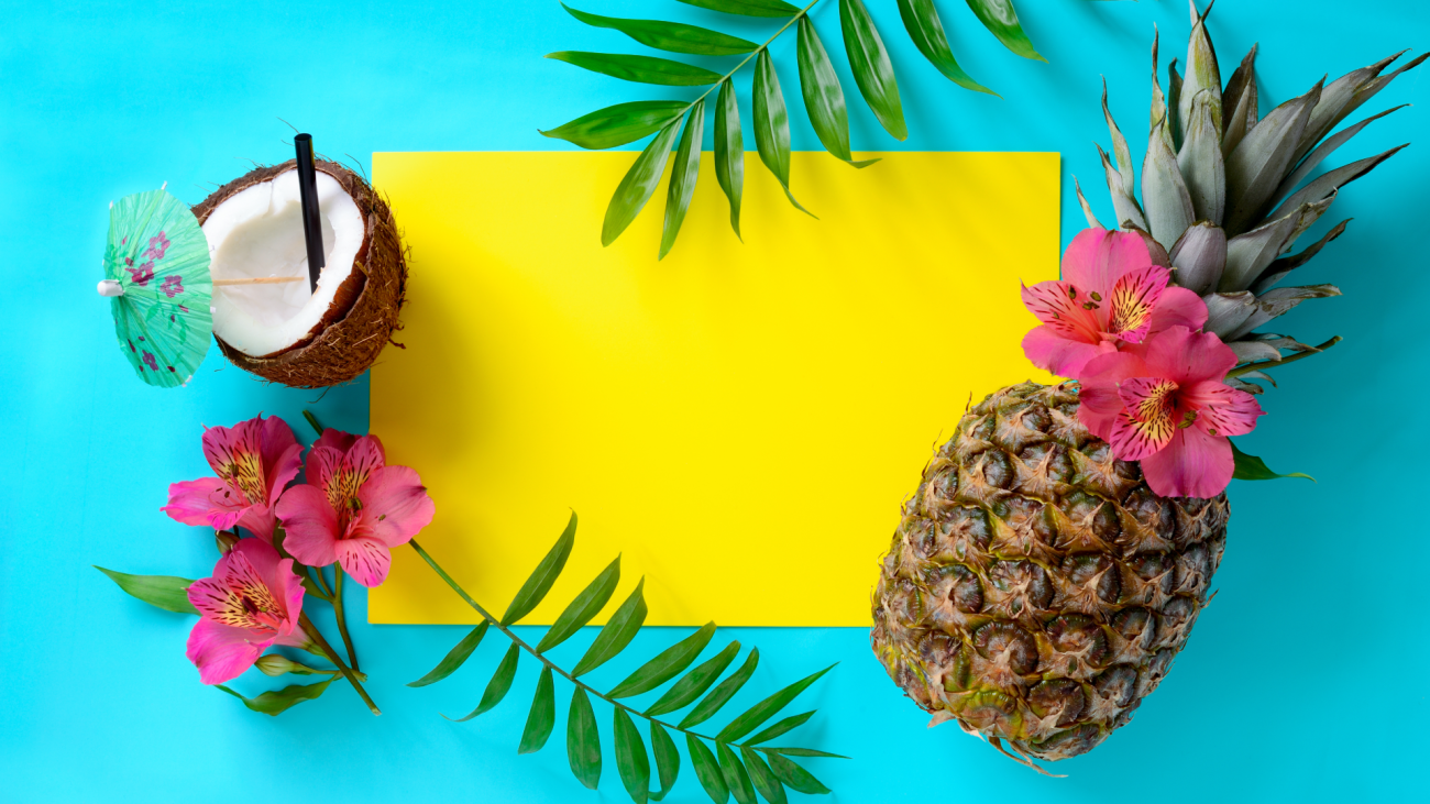 a blank yellow card surrounded by a coconut, pineapple, flowers, and pine leaves