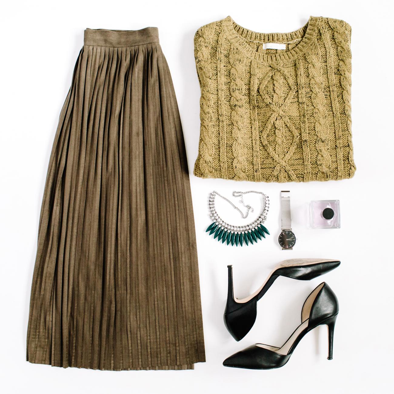 Flatlay with sweater, long skirt, black heels, and a necklace