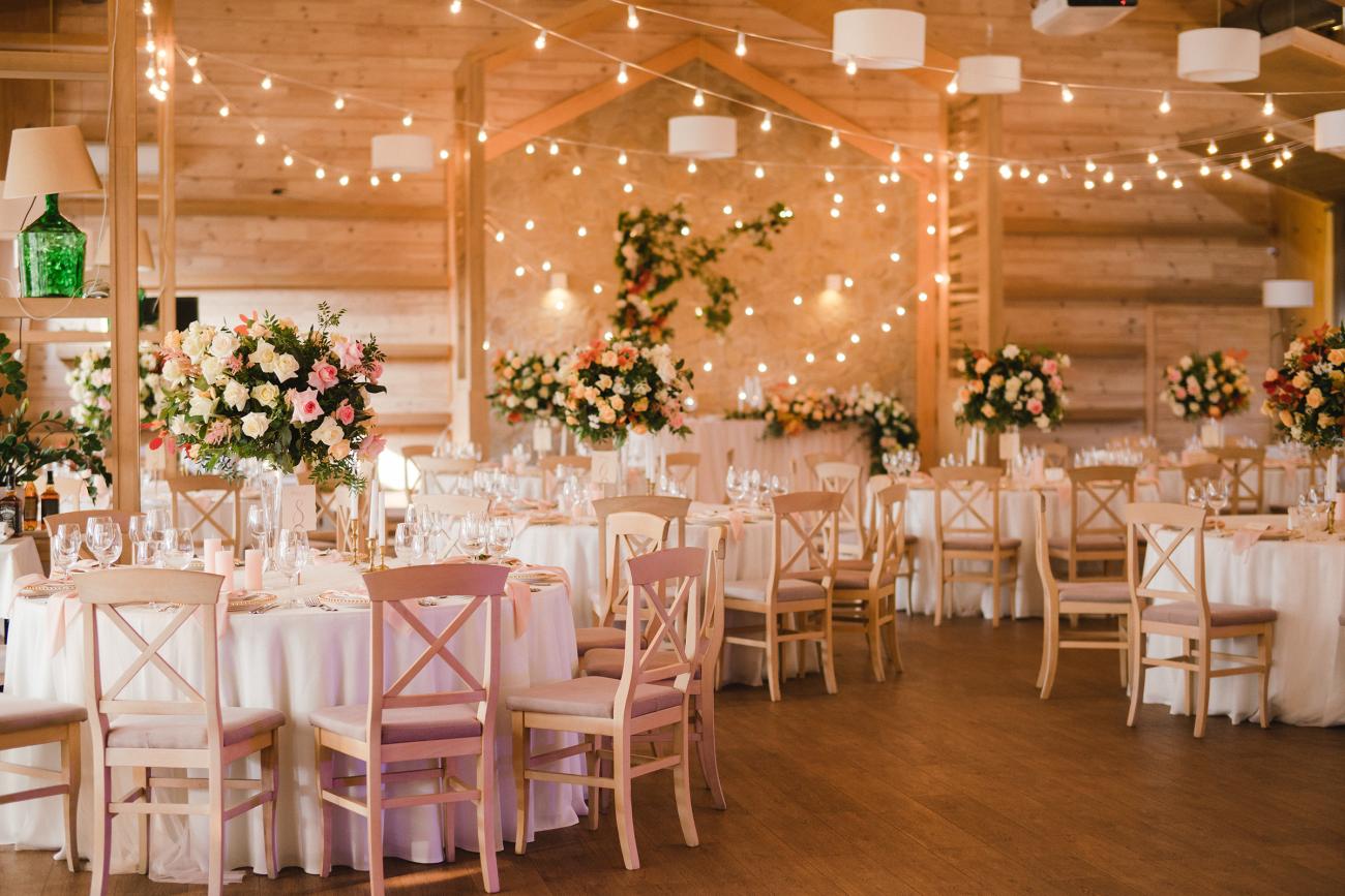 beautiful wedding reception venue with decorated tables and twinkling lights