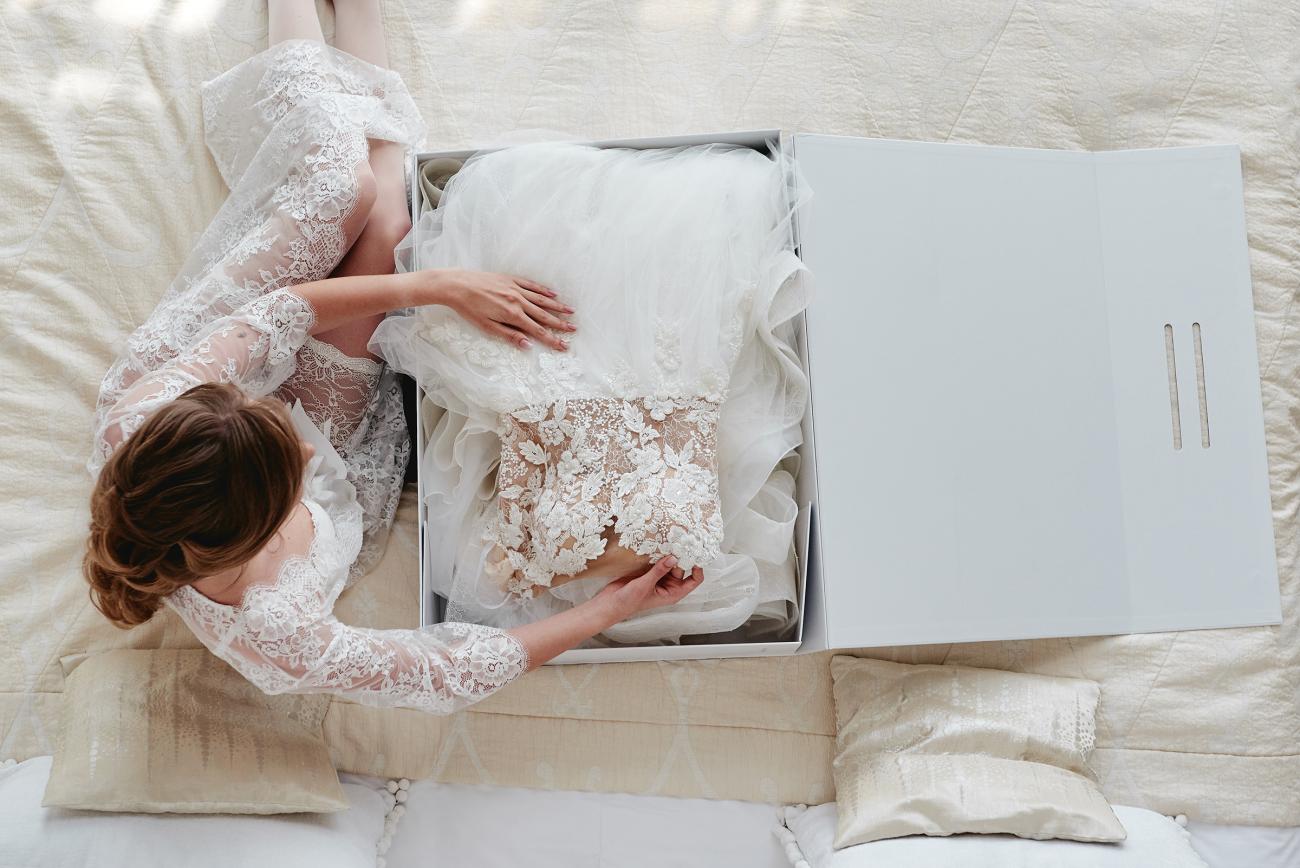 Bride unboxing her beautiful wedding dress