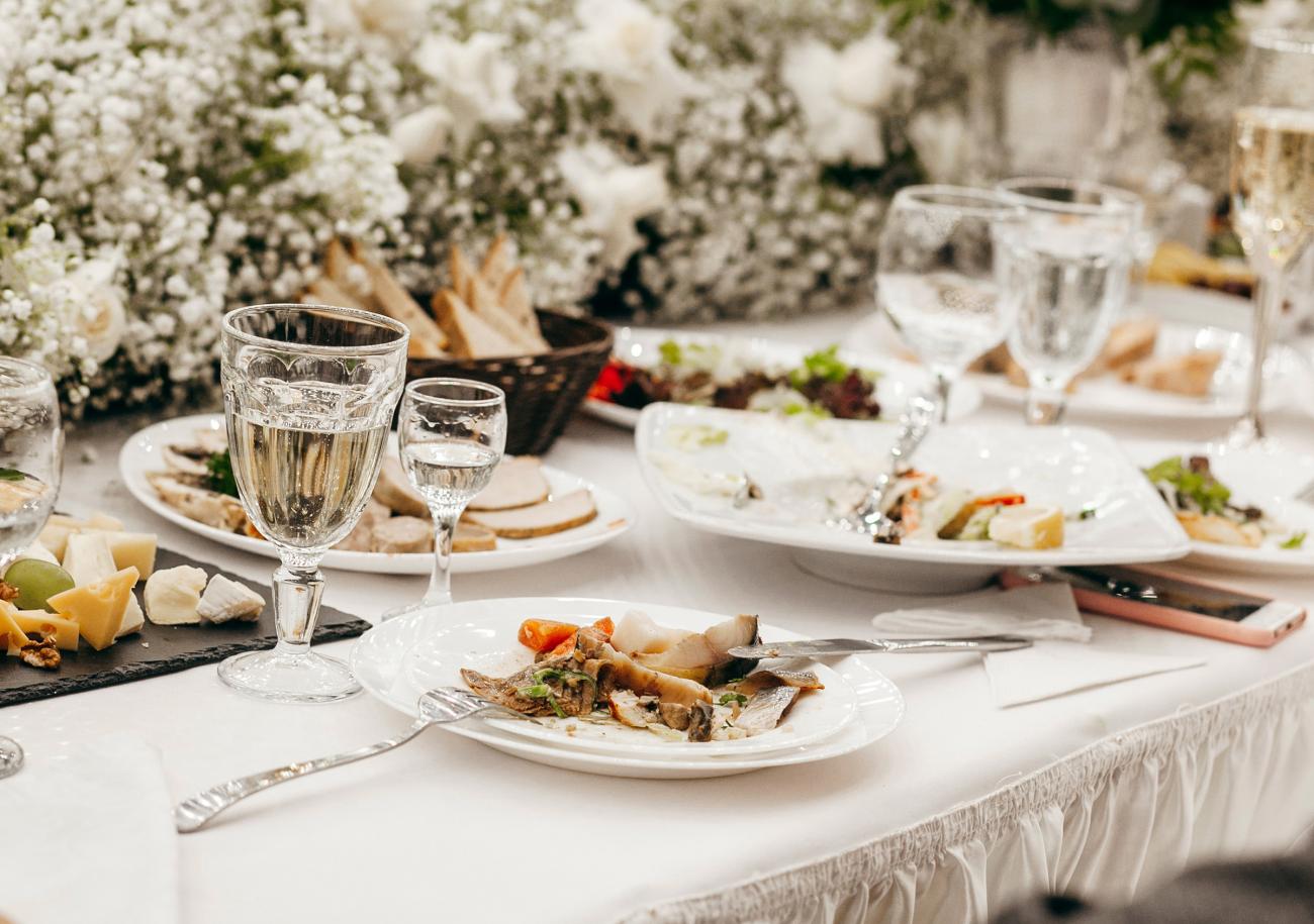 Wedding reception table with plates of food on it