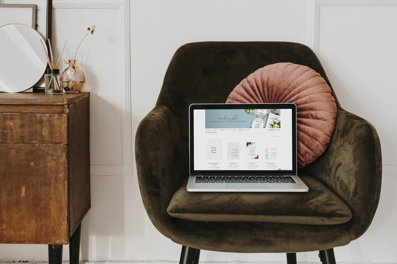 Beautiful home scene with laptop computer sitting open in velvet chair