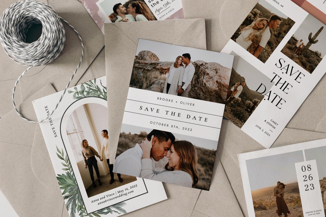 Big pile of save the dates and envelopes