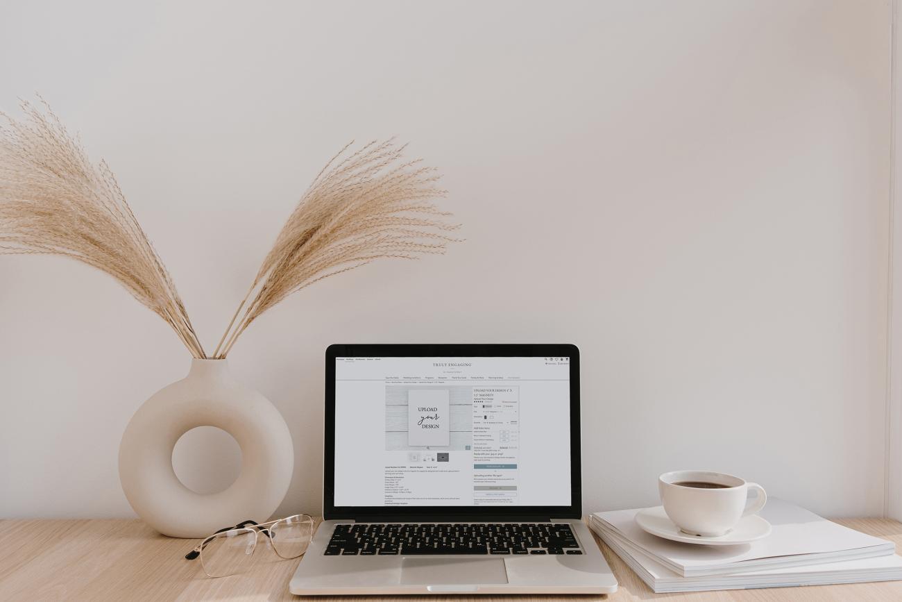 Desk with computer open to Truly Engaging website