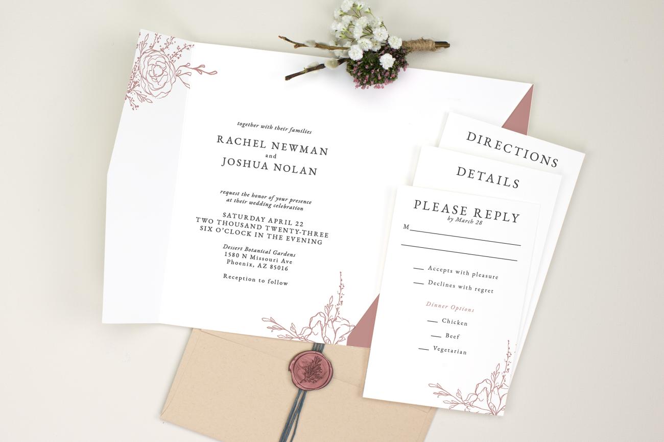 Pocket wedding invitation laying flat with step cards next to it