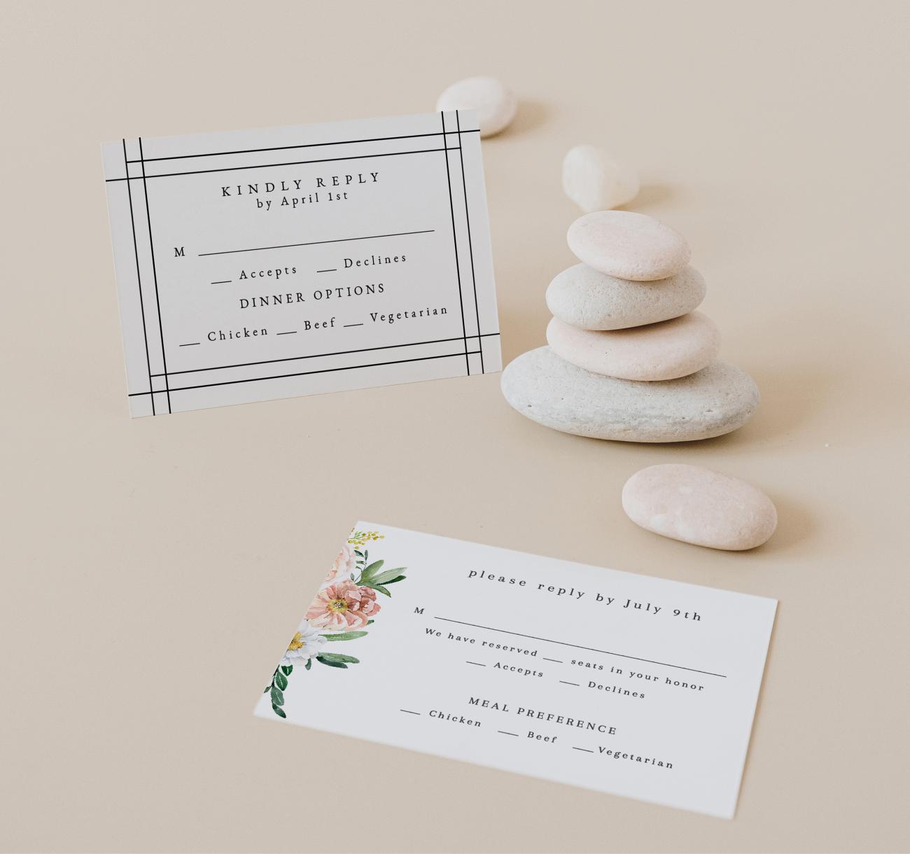 Wedding RSVP cards next to a pile of small stones