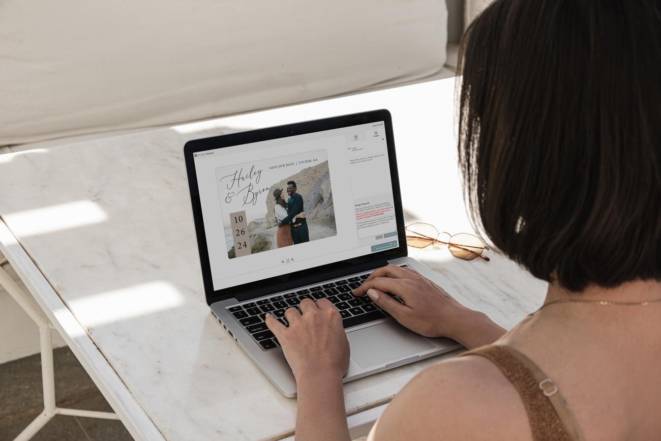 Woman on computer typing out a design request