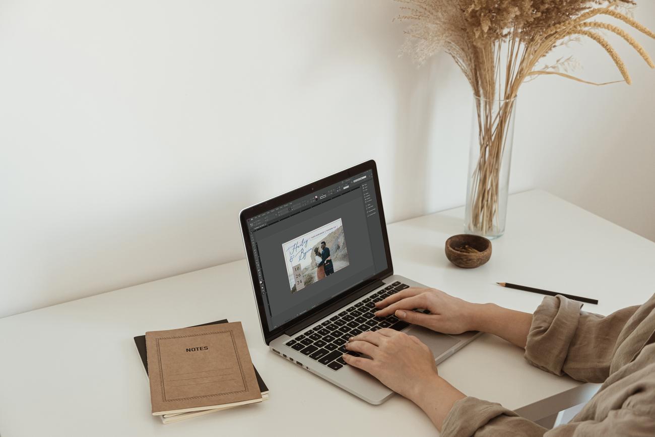Woman on the computer designing a save the date