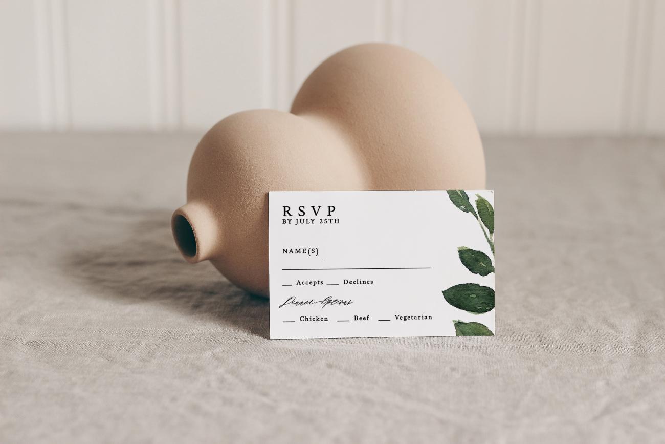 RSVP card leaning against vase