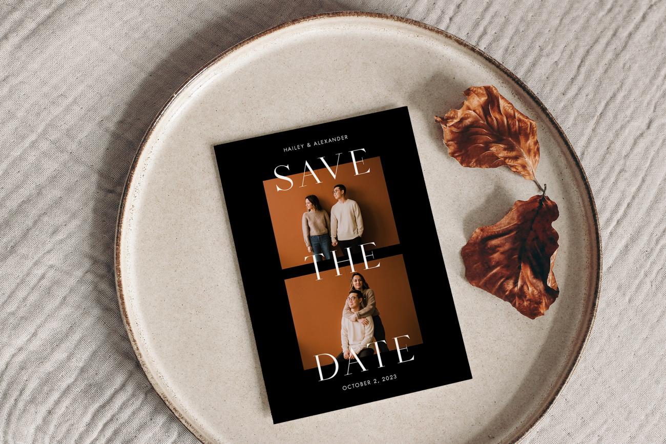 Save the date card on circular tray next to leaves