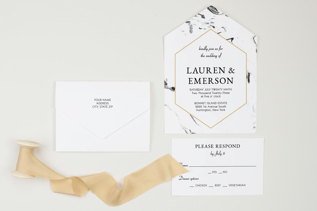 All-in-one wedding invitation laying flat next to tan ribbon