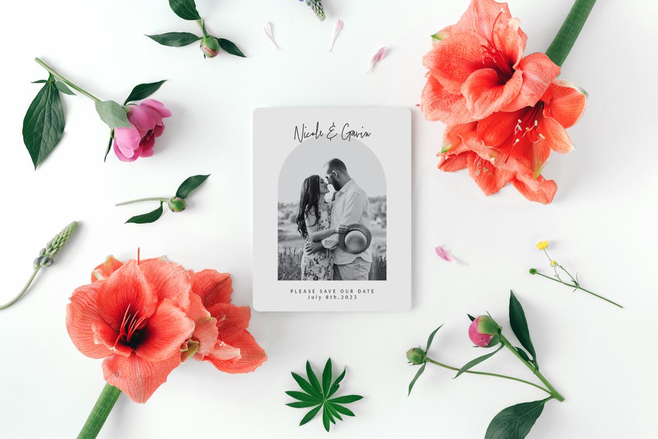 Save the date magnet surrounded by flowers and botanicals
