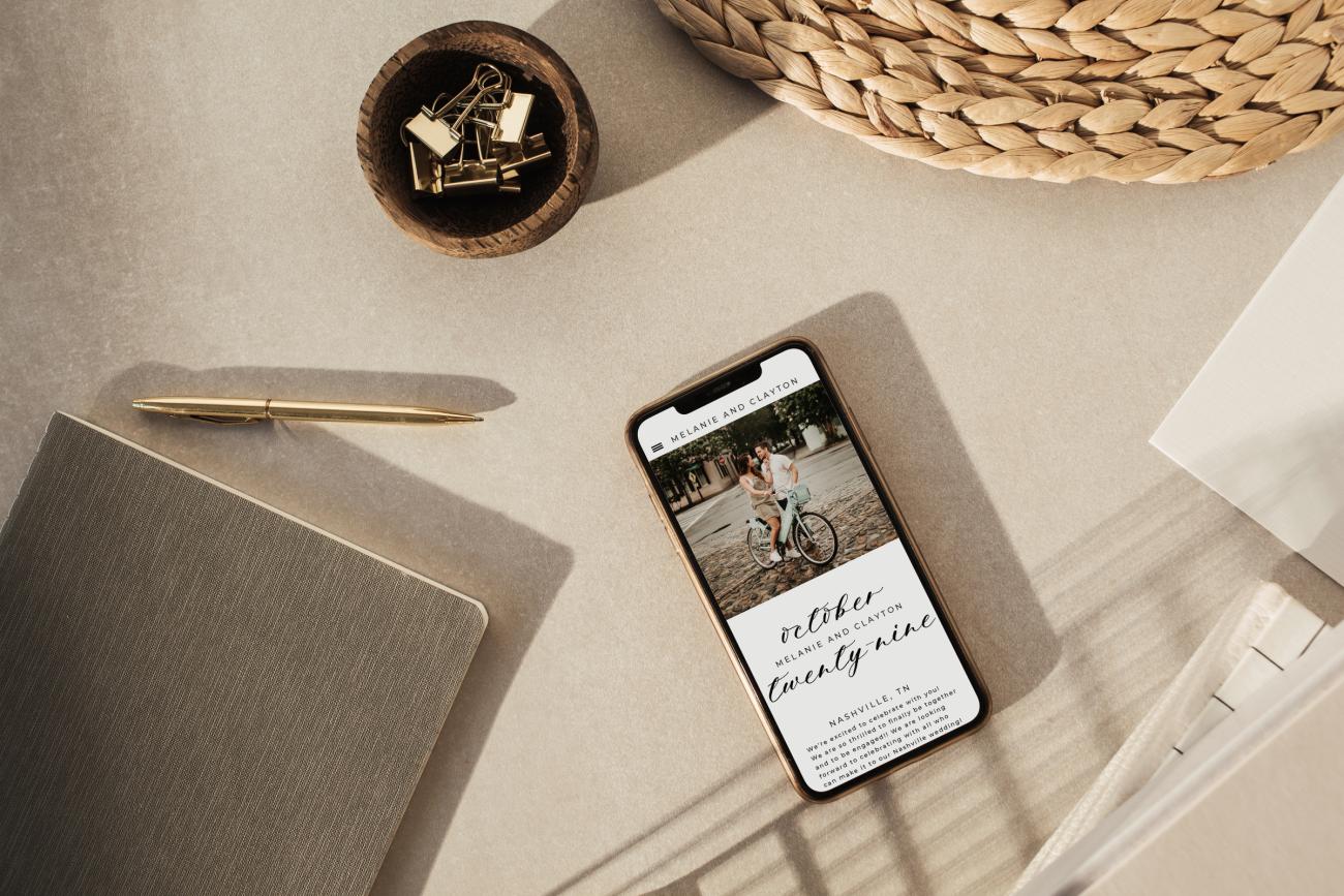 Wedding Website on a phone sitting on a desk