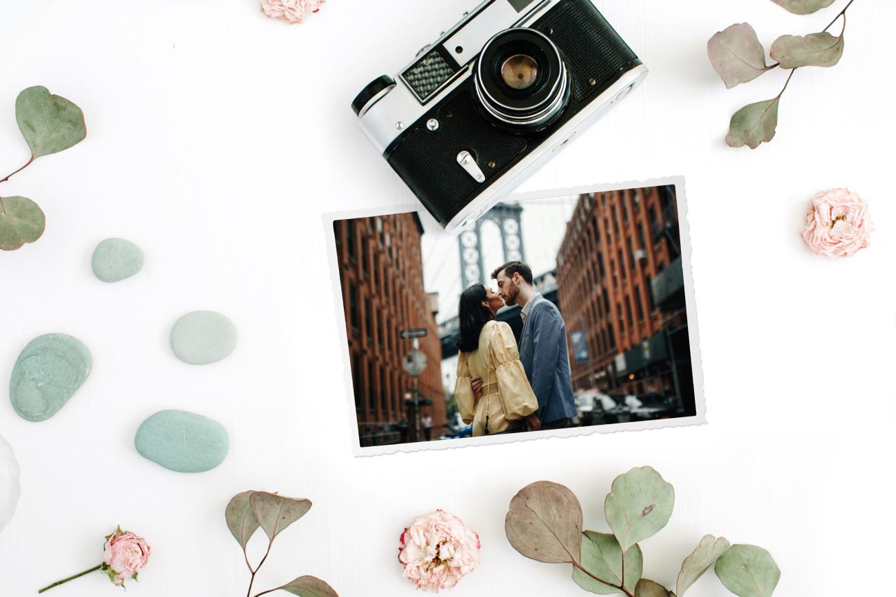 Choosing a Save the Date Photo with camera, flowers, and leaves