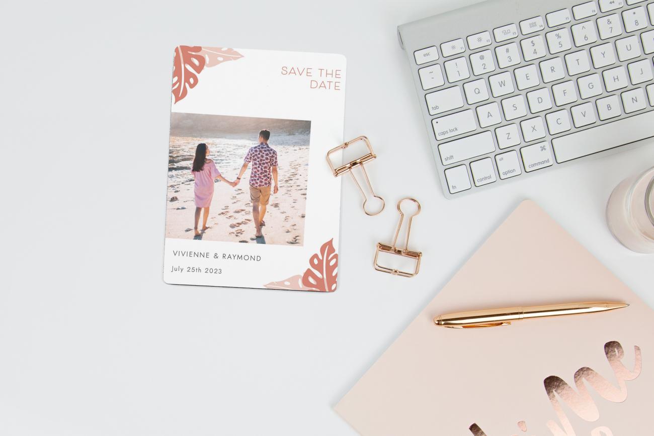 Save the Date Magnet on a desk with pretty pink accessories