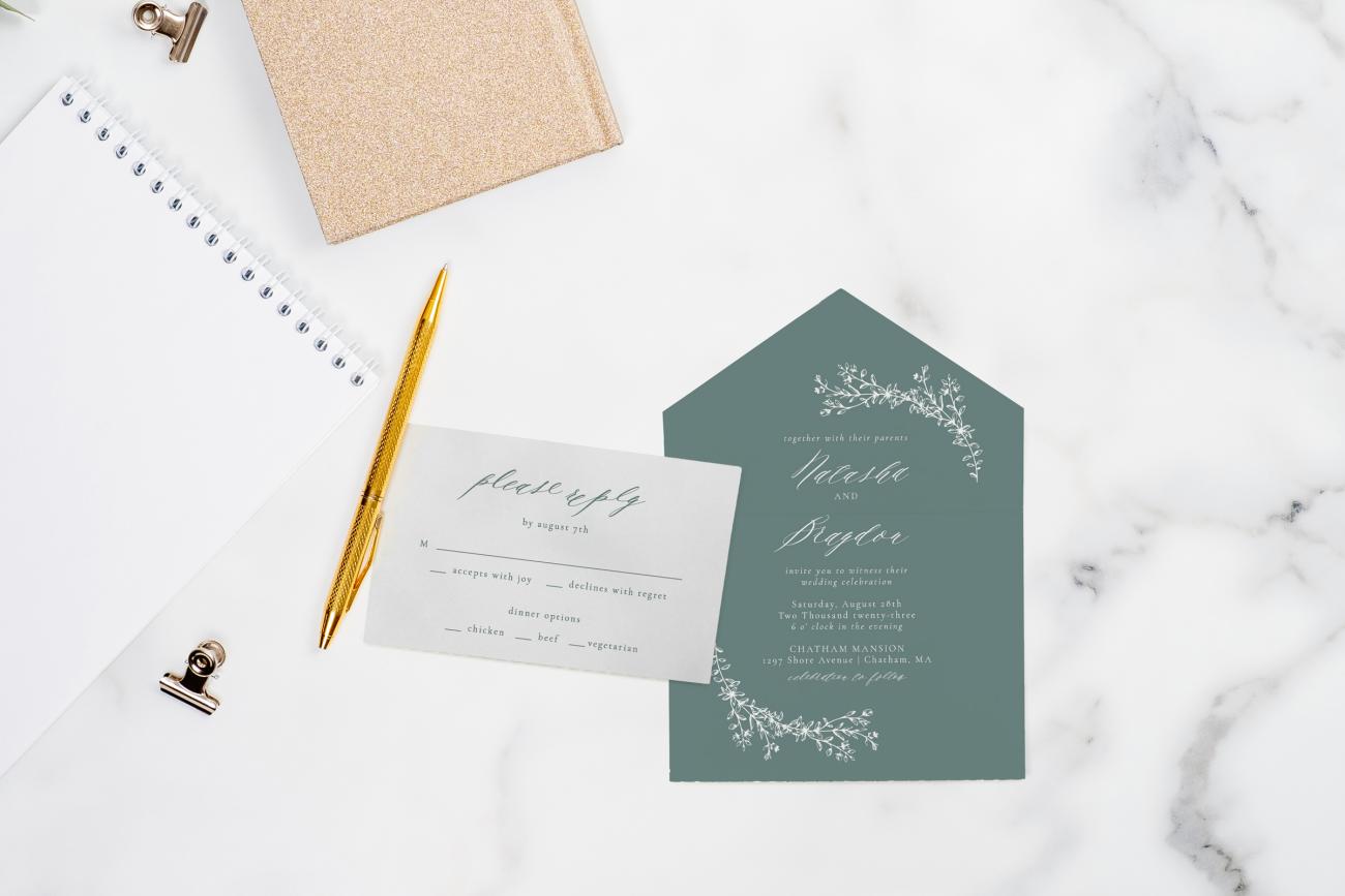 Wedding RSVP and Wedding Invitation with a pen and notebooks