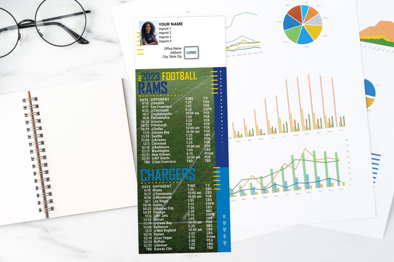Football Schedules on a desk with charts, notebook, and glasses
