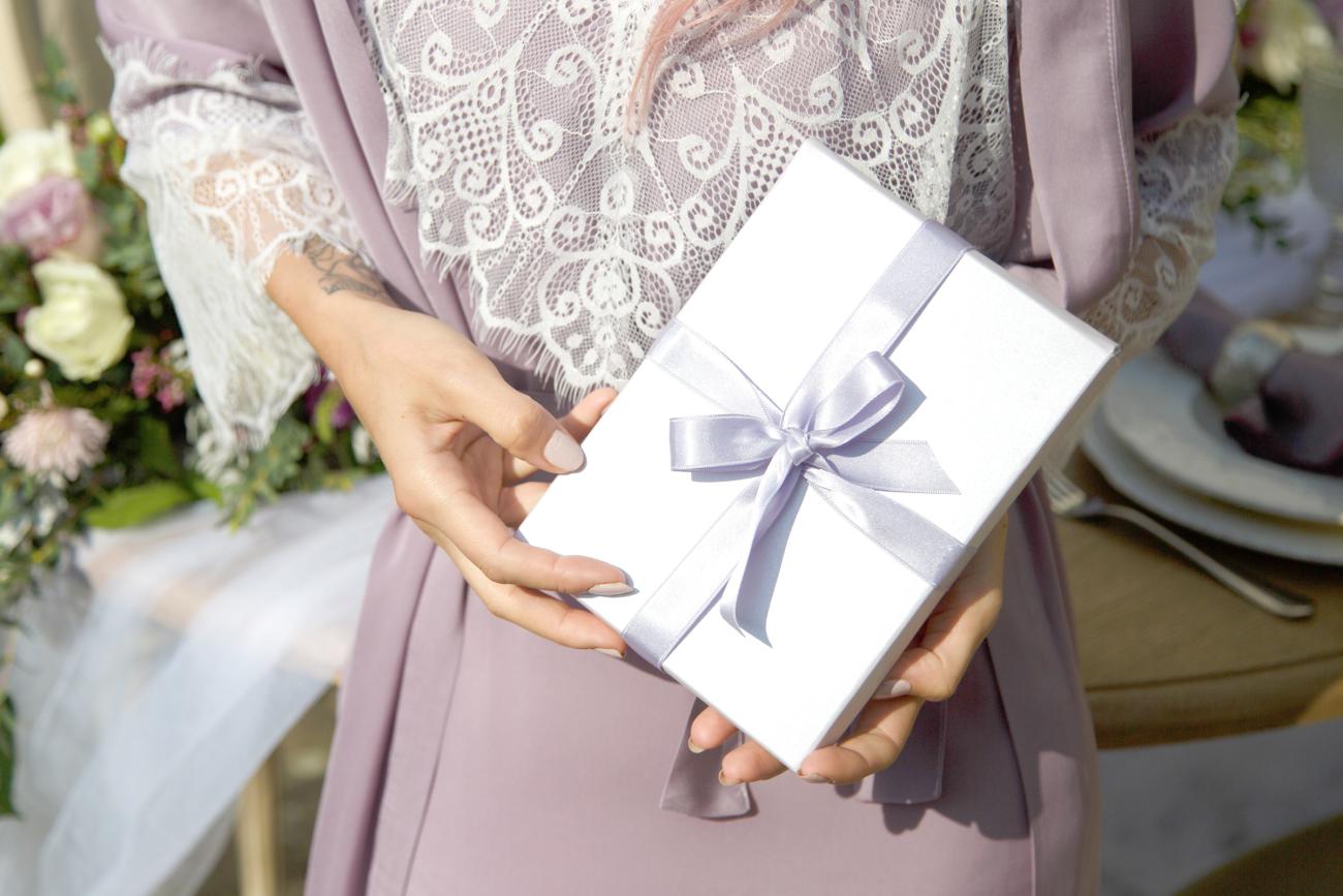 Wedding guest bringing a gift with pretty ribbon